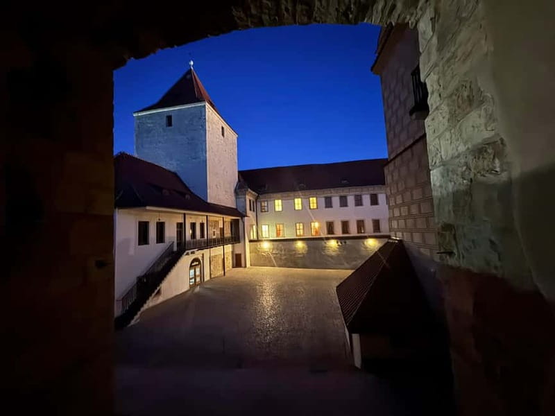 Prague: Night Walk through Prague Castle with City Views - Getting There: Malostranská Tram Ride and the White Umbrella Meeting