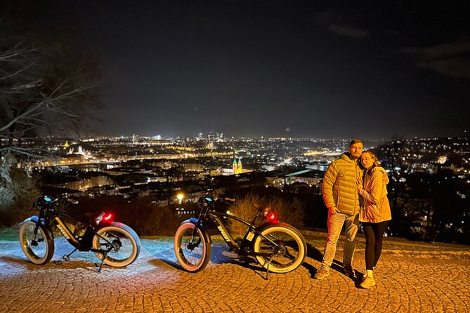 Retro Style E-Bike Night Tour in Prague - Live Guided - Charles Bridge by bike: a nighttime switch from streets to riverside